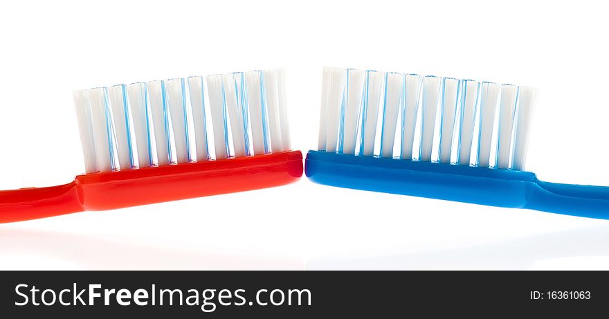 Blue And Red Toothbrushes On A White Background