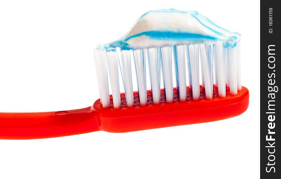 Red toothbrush with toothpaste on it