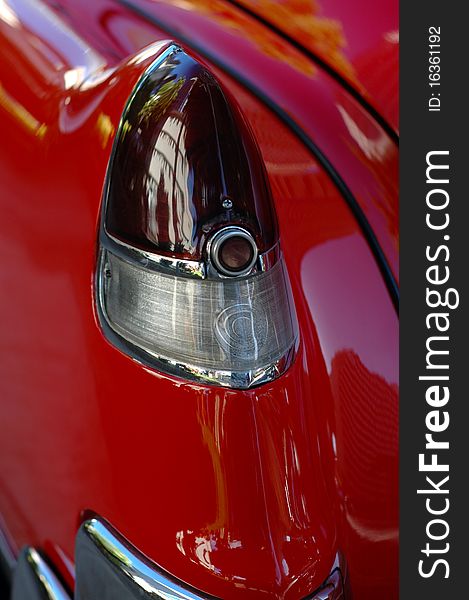 Detail of a Taillight of a Shiny, Red Classic American Car. Detail of a Taillight of a Shiny, Red Classic American Car