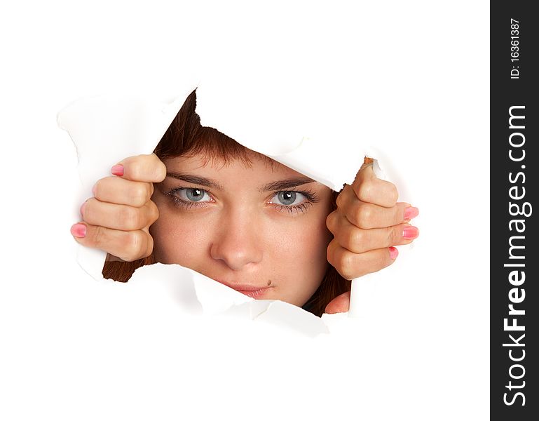 Girl is looking through a hole. Isolated on white background