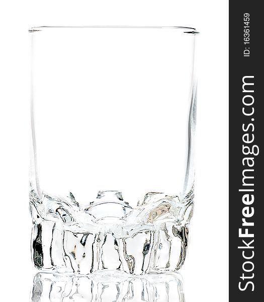 Empty glass on a white background with reflections on the floor