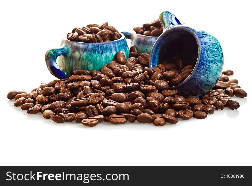 Coffee beans and cups on a white background