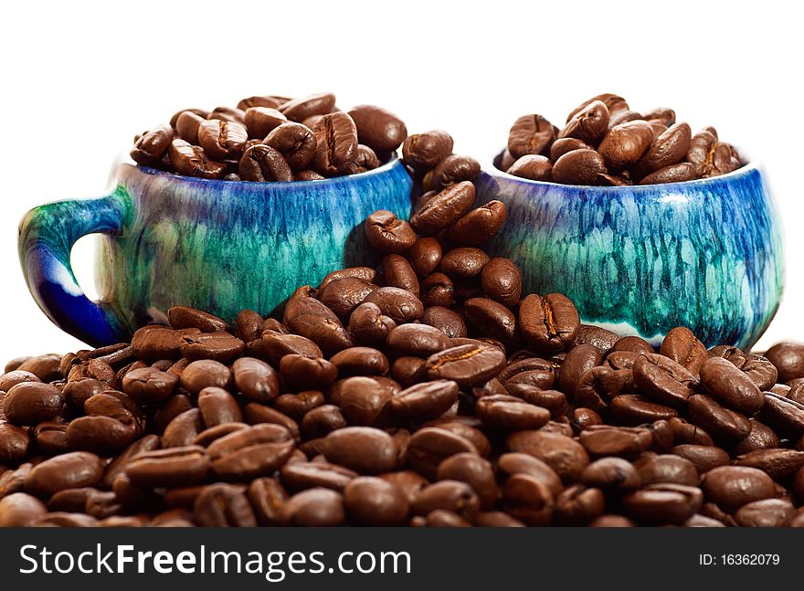 Coffee beans and cups on a white background