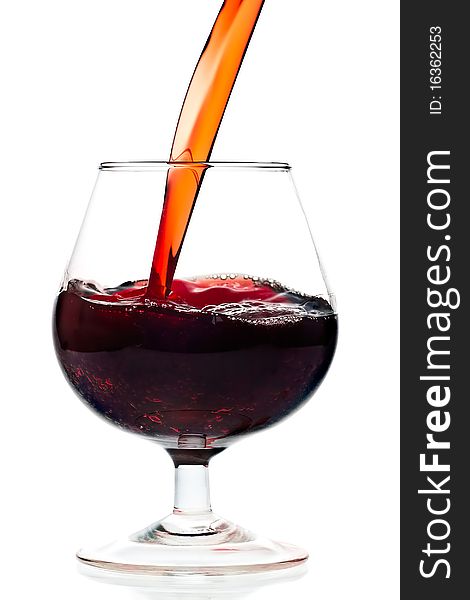 Red wine being served into a glass cup on a white background with reflections