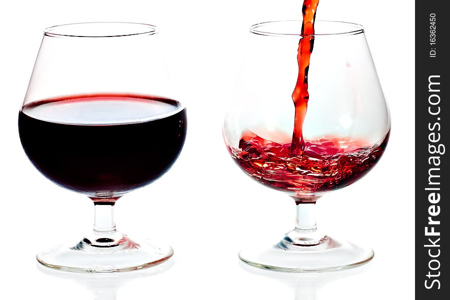Red wine being served in transparent glasses on a white background