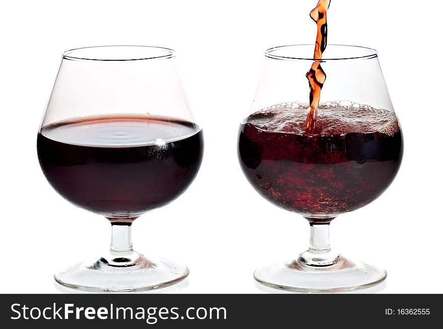 Red wine being served in transparent glasses