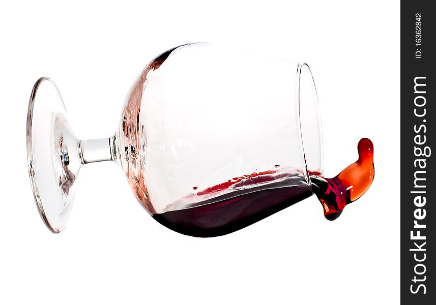 Red Wine Spilling From A Transparent Glass