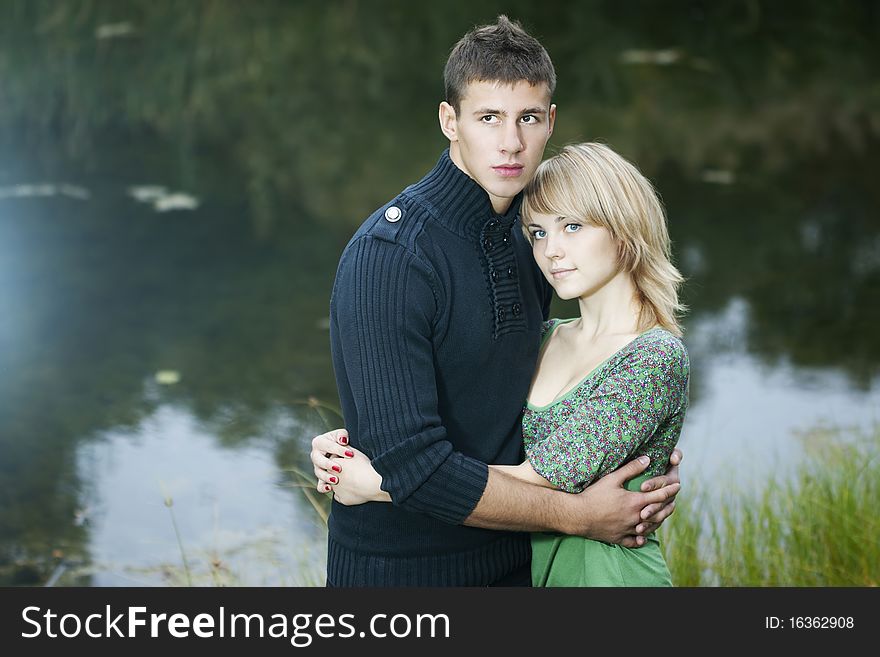 Happy young couple in love hugging on the lake. Happy young couple in love hugging on the lake