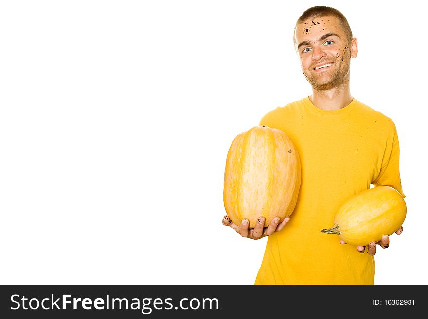 Handsome young man holds a lot of different pumpkin in his hands. Lots of copyspace and room for text on this isolate. Handsome young man holds a lot of different pumpkin in his hands. Lots of copyspace and room for text on this isolate