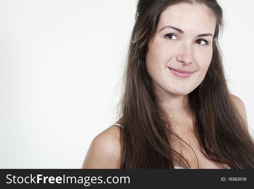 Portrait of beautiful young smiling girl with freckles, isolated on white background