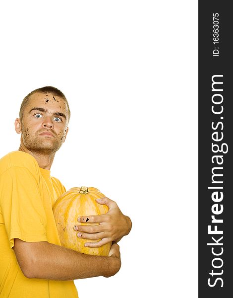 Young man squeezes with both hands a pumpkin face and hands stained the ground. Approximation of Halloween. Isolated on a white background