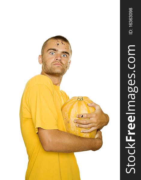 Young man squeezes with both hands a pumpkin face and hands stained the ground. Approximation of Halloween. Isolated on a white background