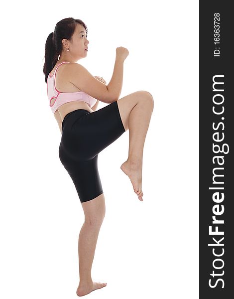 An Asian woman doing some kickboxing exercise. An Asian woman doing some kickboxing exercise