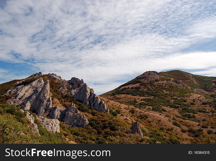 White clouds over mountains in autumn