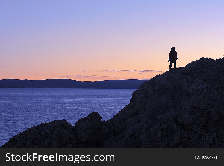 Silhouette of a photographer at daybreak on the top of mountains in Tibet.