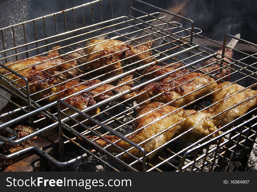 Grilled chicken on the barbeque close-up