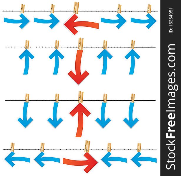 Differently directed red and dark blue arrows by means of clothespins hang on a barbed wire