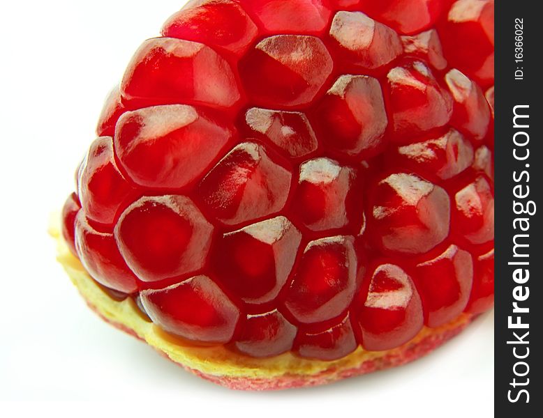 Segment of a ripe pomegranate on a white background close up