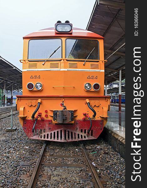 Closeup of Yellow diesel train locomotive on Platform of Bangkok Railway Station Thailand.