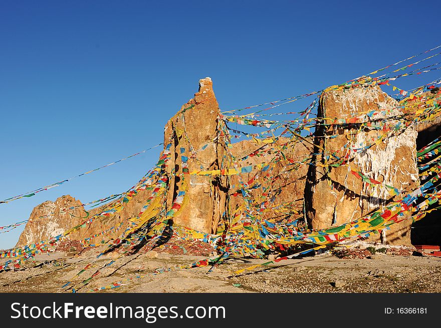 Scenery of flying colorful prayer flags around huge rock in Tibet. Scenery of flying colorful prayer flags around huge rock in Tibet.