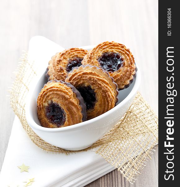 Linzer cookies in white bowl decorated