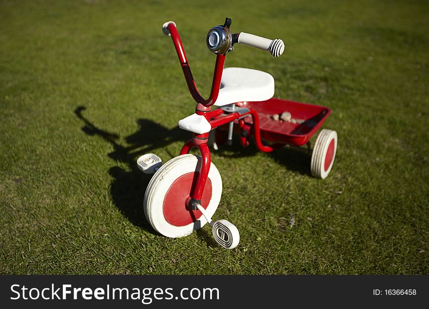 Redbike on  a green field