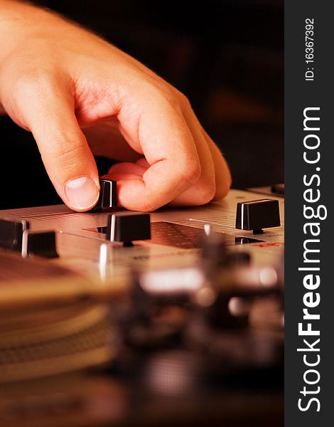 Hand of a disc jockey on the professional mixing controller. Hand of a disc jockey on the professional mixing controller