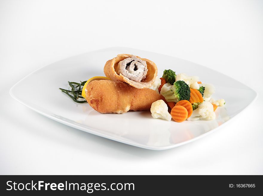 Delicious meat role with vegetables on a plate