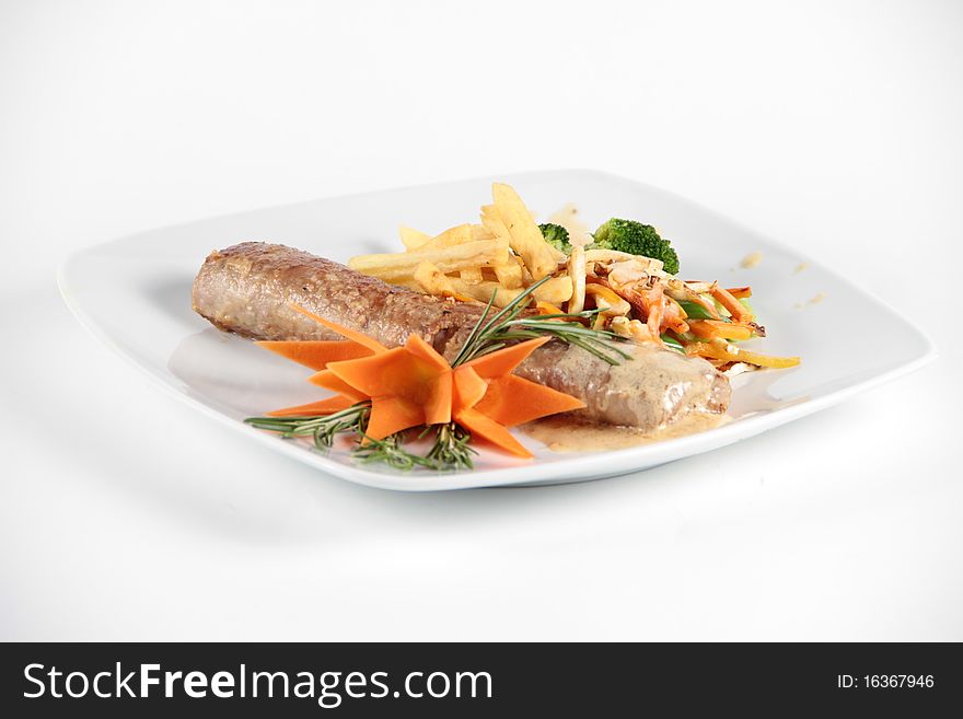 Meat role combined and served with vegetables on a plate. Meat role combined and served with vegetables on a plate