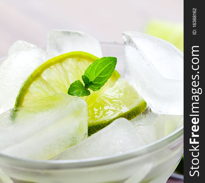 Ice cubes in glass with lime slices. Ice cubes in glass with lime slices