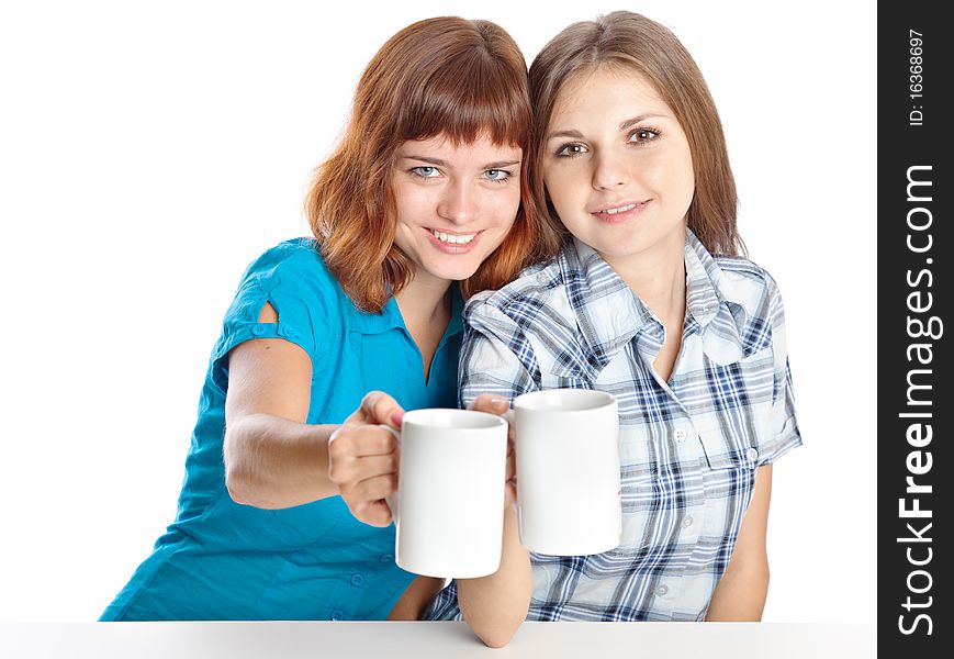 Two teen-girls are drinking tea