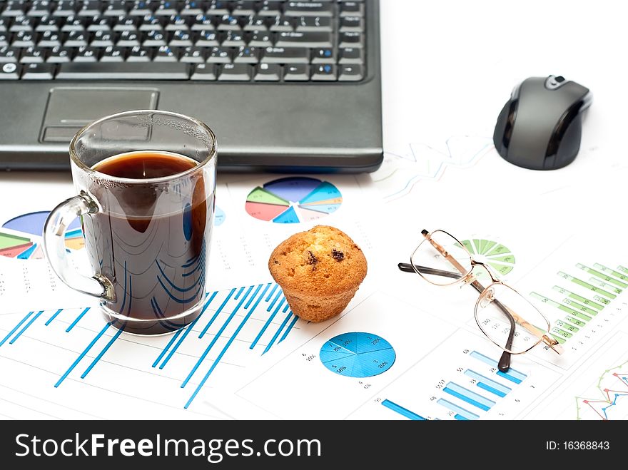 Business still-life with diagrams, glasses, coffee, cake and notebook. Business still-life with diagrams, glasses, coffee, cake and notebook