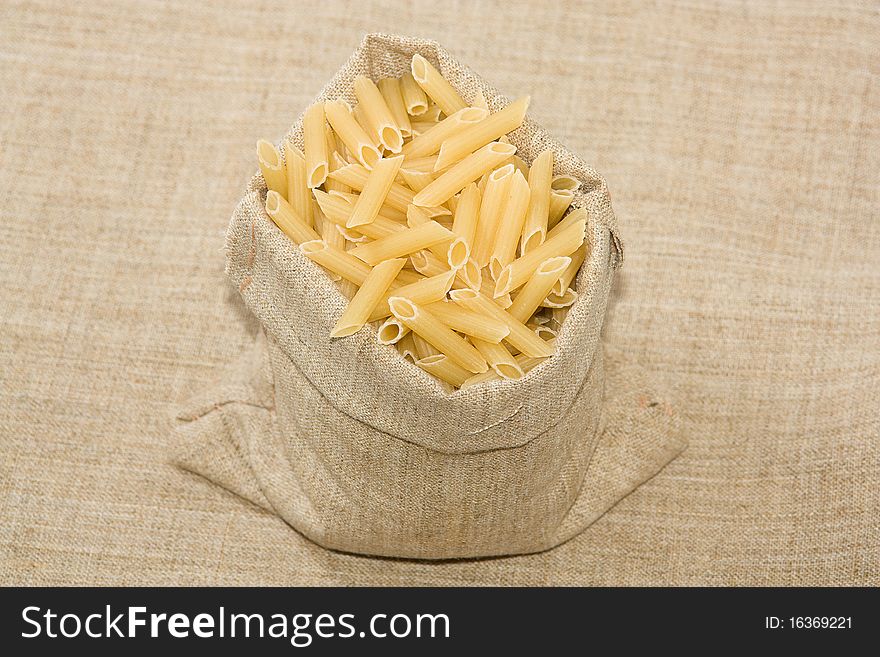 Burlap sack  full with raw  macaroni