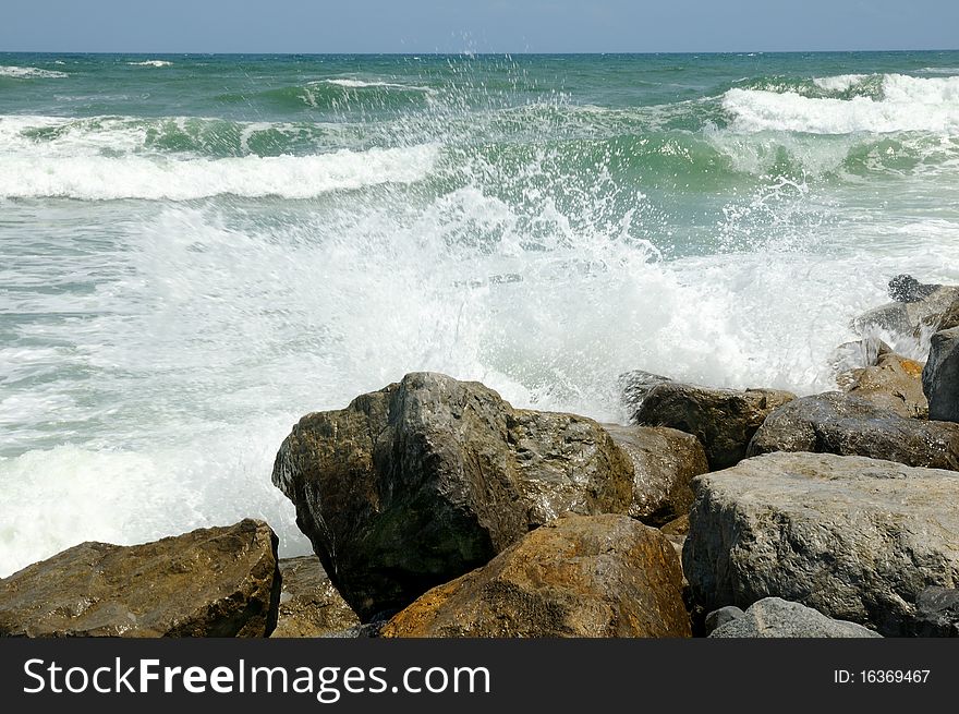 Waves crashing over the rocks in the surf at New Smyrna Beach, Florida. Waves crashing over the rocks in the surf at New Smyrna Beach, Florida.