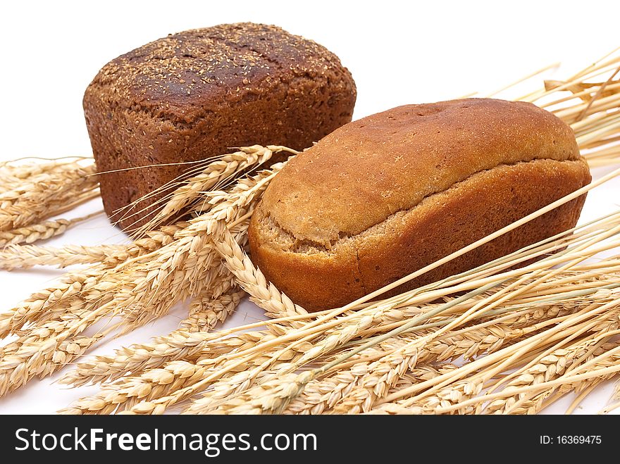 Bread with wheat and ears on white