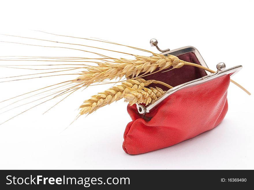 Red purse with wheat ears on white