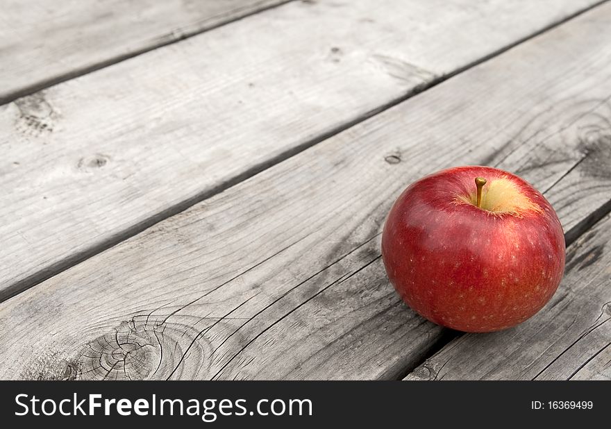 Red Apple On Old Wooden Table