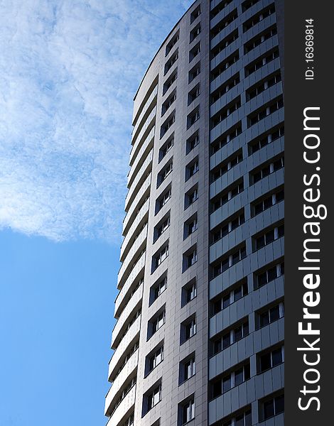 Closeup of high modern building on blue sky background