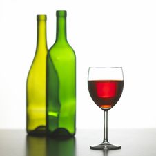 Glass Of Red Wine With Two Green Wine Bottles Stock Photography Glass Of Red Wine With Two Green Wine Bottles Stock Photography