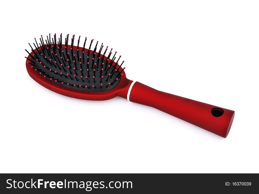 Red comb the hair on a white background. Red comb the hair on a white background