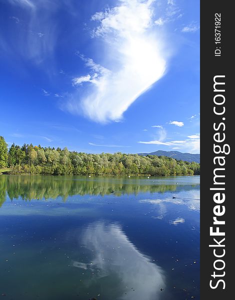 Blue lake with colorful wood and blue sky in autumn. Blue lake with colorful wood and blue sky in autumn