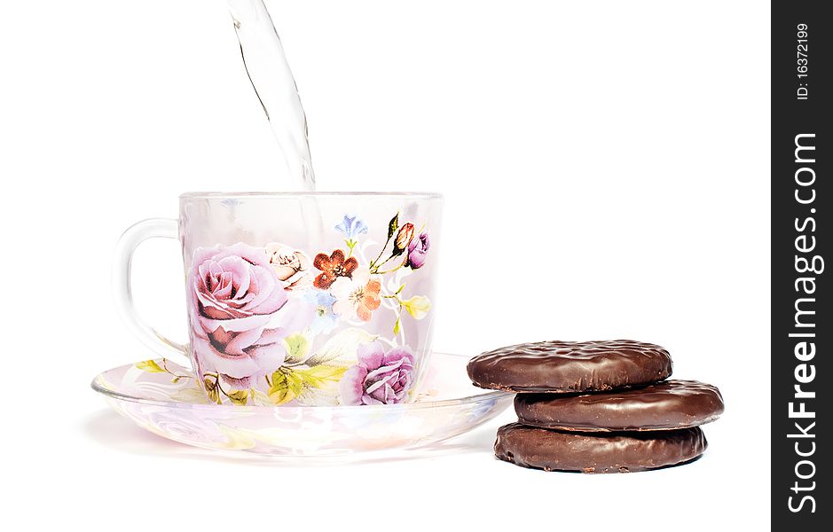 A cup of tea on the saucer with chocolate cookies. A cup of tea on the saucer with chocolate cookies