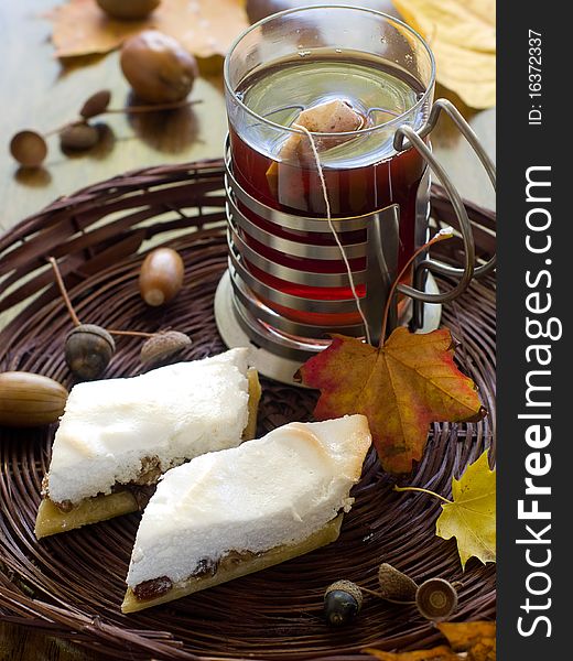 Cake with raisins in a basket with tea in the background. Cake with raisins in a basket with tea in the background