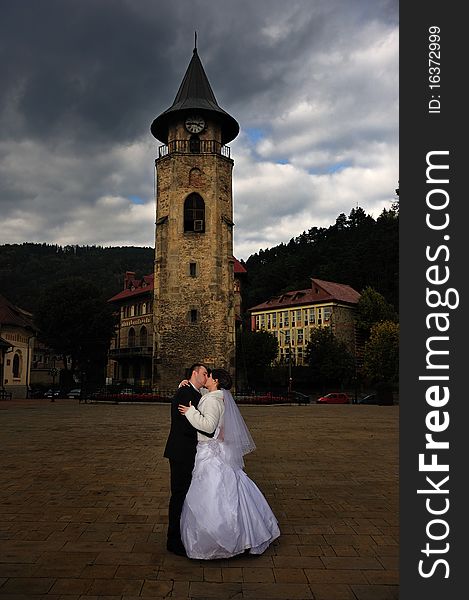 Groom kissing his bride on the neck. Groom kissing his bride on the neck