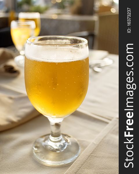 Glass beer on the table in restaurant.