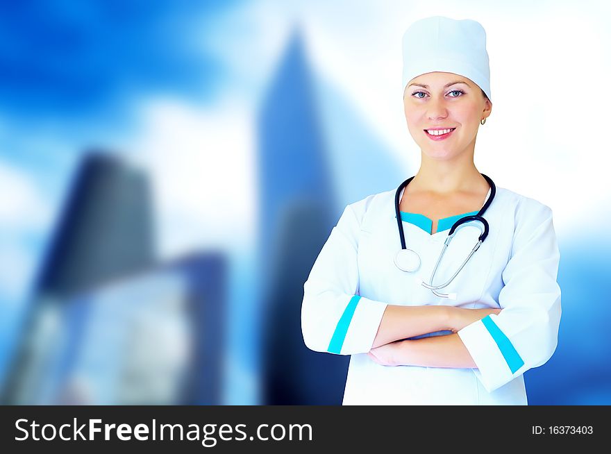 Smiling medical doctor with stethoscope on the hospitals background