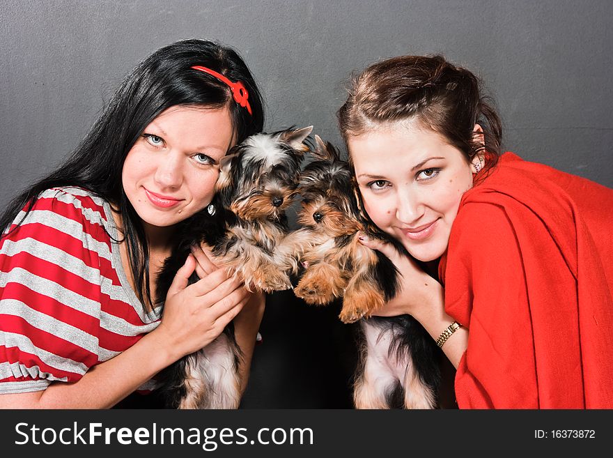 Two girls pose with terriers. Two girls pose with terriers