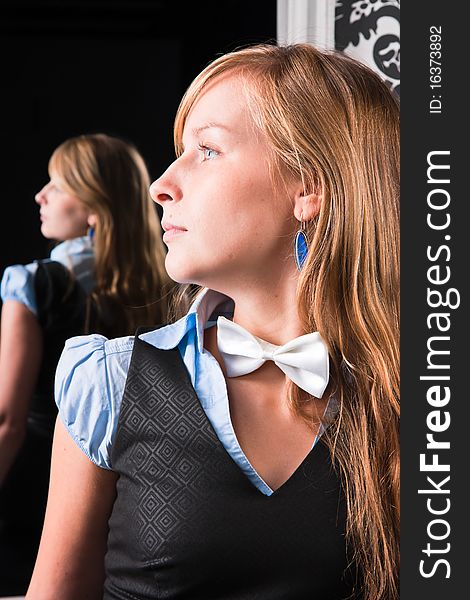 Profile of a young woman against the backdrop of mirror