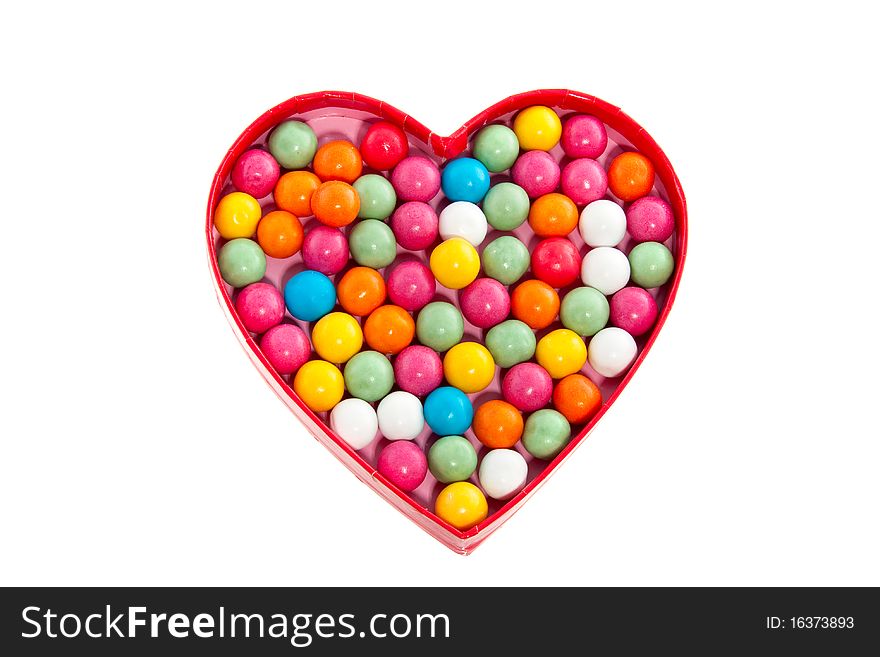 Gumballs in the shape of a heart isolated on white background