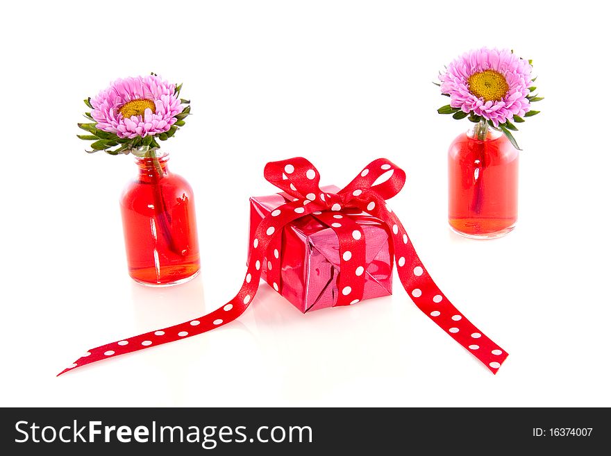 A little present between carnation flowers isolated white background